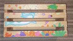 a wooden crate with sea animals painted on it