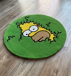 a rug with the face of homer from the simpsons is shown in front of a wooden floor