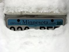 the minnesota license plate is covered in snow