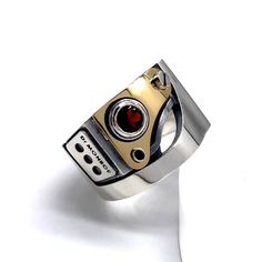 Industrial design and mechanical ring. For steampunk & biker fashion. Brutalist jewelry. made in JAPAN.  Height :      0.61inch ± Thickness :  0.20inch ± Stone size:  0.19 inch   18k gold(750)  sterling silver(925) Blue topaz or Garnet  You will need your phone number when shipping from Japan.  Please message your phone number when ordering.  In stock or not, that's changes every day. If in stock, we'll ship in a few business days, but if out of stock, we need about 2-3 weeks to shipping. We won't accept any returns or exchanges unless the products are faulty. Mechanical Ring, Mens Silver Earrings, Industrial Ring, Steampunk Rings, Present For Him, Biker Rings, Ring For Men, Steam Punk, Gold Plated Rings