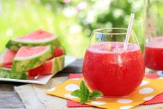 watermelon juice in a glass on a table with slices of watermelon