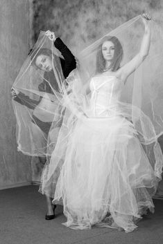 two women dressed in costumes with veils