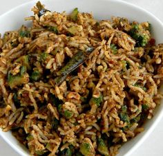 a white bowl filled with rice and vegetables