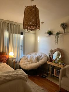 a bedroom with a bed, chair and table in it