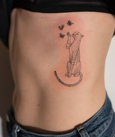 a woman with a cat tattoo on her stomach