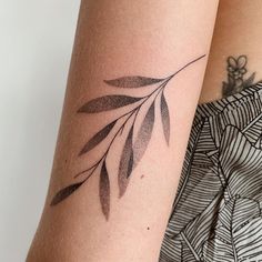 a woman's arm with a small tattoo on the left side of her arm