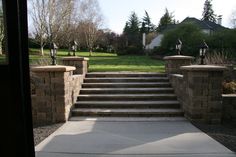 the steps lead up to the front door of a house with trees in the background