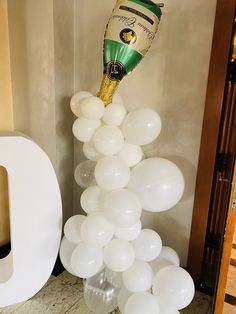 balloons are being blown into the air by a champagne bottle