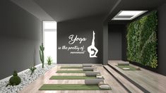 yoga mats and succulents are arranged in an empty room with green plants on the wall