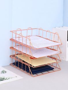 a stack of folders sitting on top of a desk next to a binder