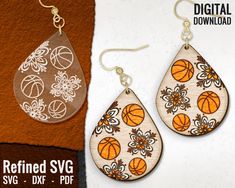 a pair of earrings with basketballs and flowers on them