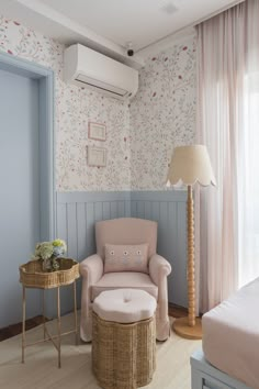 a chair and ottoman in a room with wallpaper on the walls, floor to ceiling curtains