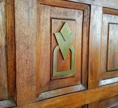 a close up of a wooden cabinet with an arrow on the front and bottom panel