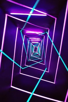 an image of a tunnel with neon lights going through it and the light at the end is purple