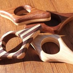 three wooden toys are sitting on a table