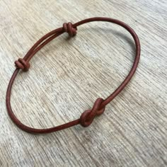 a brown leather cord bracelet on top of a table