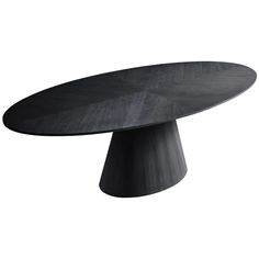 an oval table with black wood grain on the top, and a circular wooden base