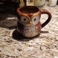 an owl mug sitting on top of a counter