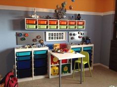 a child's playroom with toys and storage bins