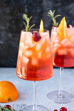 two glasses filled with orange and cranberry punch