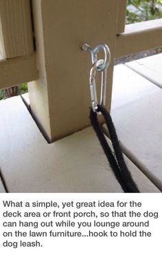 a dog leash tied to the side of a wooden door with a chain hanging from it