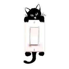 a black cat is sitting on top of a light switch cover and it's eyes are wide open