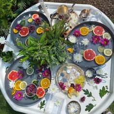 an overhead view of a platter filled with fruit and flowers