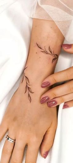 a woman's hand with a flower tattoo on it