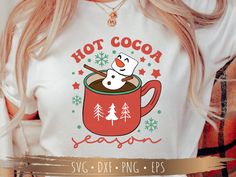 a woman wearing a hot cocoa season t - shirt with a snowman on it