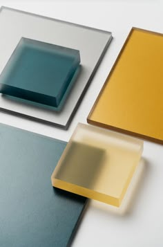 three different colors of glass sitting on top of each other