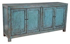 an old blue cabinet with three doors and two drawers on one side, against a white background