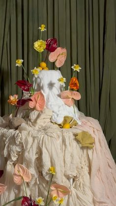 an arrangement of flowers on top of a bed