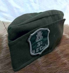 a green hat with an emblem on it