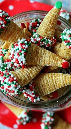 christmas crackers in a glass jar with candy canes and sprinkles