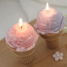 two ice cream cones with candles in them