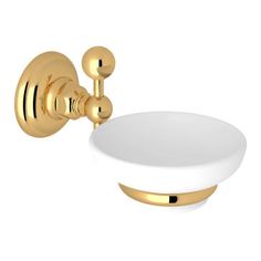 a gold faucet with a white bowl on it