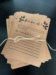 four brown paper tags tied together with twine