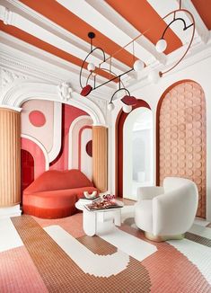 a living room filled with white furniture and orange accents on the walls next to windows