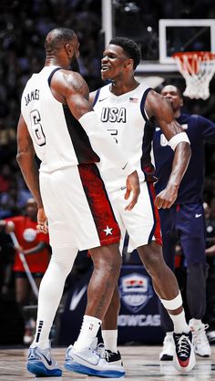 two men standing next to each other on a basketball court