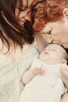 a woman holding a baby in her arms