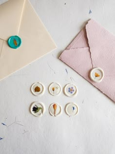 some buttons are sitting next to an envelope