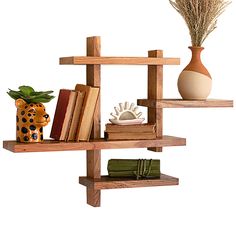 a wooden shelf with books, vase and other items on it in front of a white background