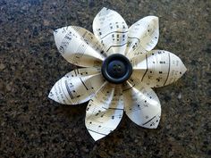 an origami flower made out of sheet music