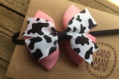 "I love the combination of cow print with pink , it's so cute. This hair bow headband is perfect for any little country cutie. Great headband for girls of all ages. A must have hairbow for Summer. Made with quality grosgrain ribbon and measuring approximately 3 inches across by 3 inches tall. Hair bow is attached to a skinny elastic headband. Simple and yet super cute. Size Chart 13\" ~ newborn 14\" ~ 3-6 months 15\" ~ 6-12 months 16\" ~ 12- 24 months 17\" ~ 2T- Teen 19\" ~ Adult Headband is 1/4 Cute Pink Bow Headband As Gift, Cute White Headband For Birthday, Cute White Headband With Pink Bow, Cute White Birthday Headband, Fun Hair Accessories With Matching Headband For Birthday, Cute Pink Bow Headband, Cute Adjustable Pink Headband, Fun Birthday Hair Accessories With Matching Headband, Cute Pink Summer Headband