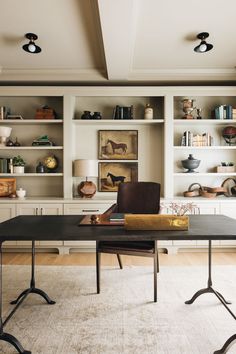 an instagram photo of a home office with built - in bookcases and shelving