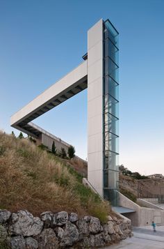 a tall building sitting on the side of a hill