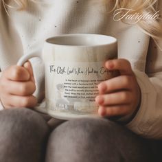 a woman holding a coffee mug with her hands