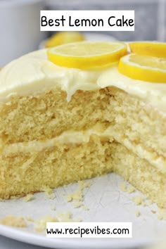 a cake with white frosting and lemons on top is cut in half to show the inside