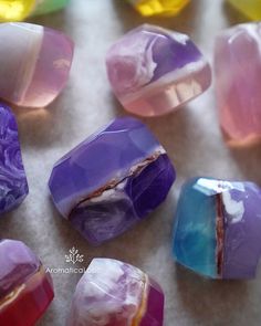 several different colored rocks sitting on top of a table