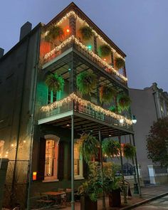 a building with christmas lights on the balconies